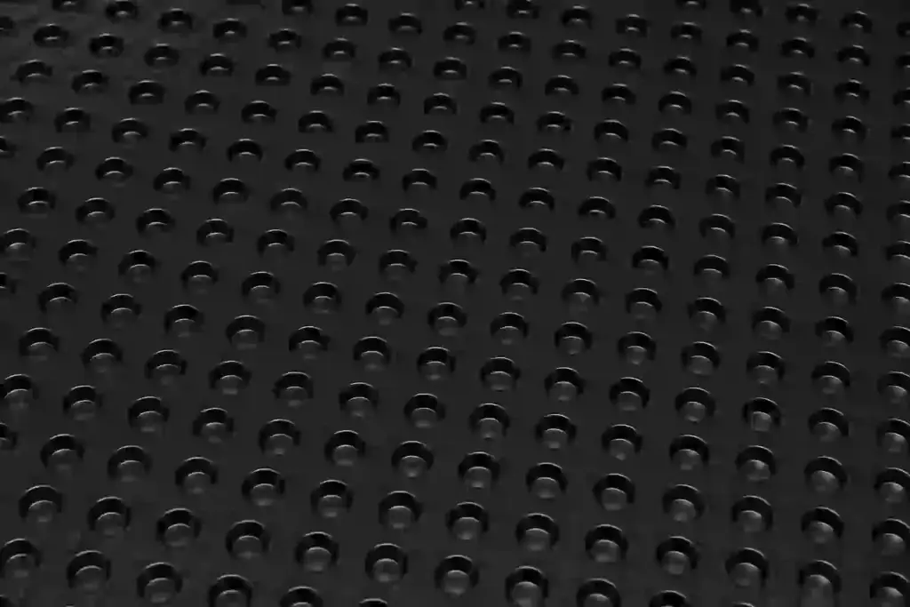 Close-up texture of black HDPE drainage board used for exterior foundation waterproofing in Ontario
