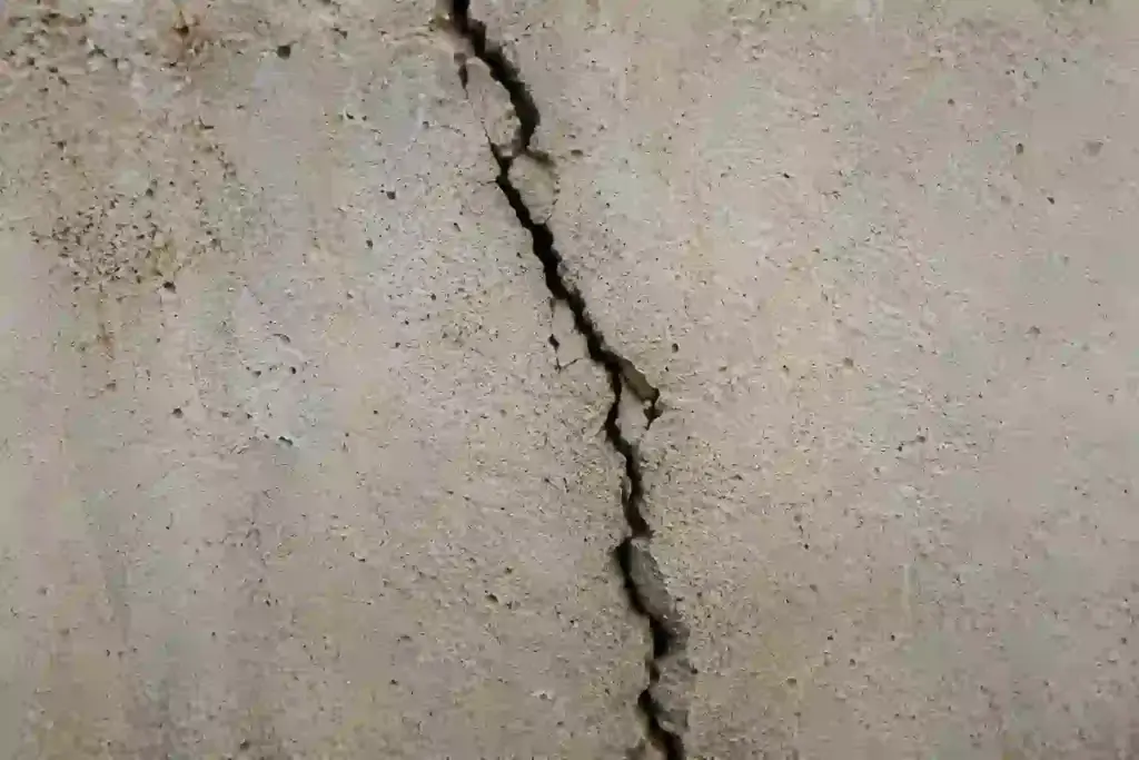 Vertical crack in a residential Ontario basement foundation wall showing signs of structural movement and water intrusion risk